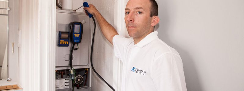 Close up of engineer fixing boiler A & D Plumbing Services