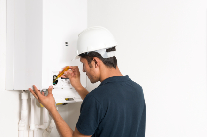 Close up of engineer fixing boiler A & D Plumbing Services
