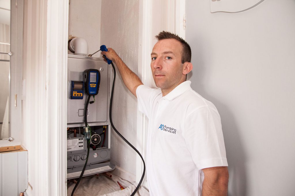 AandD Plumbing Services engineer installing a boiler on-site.